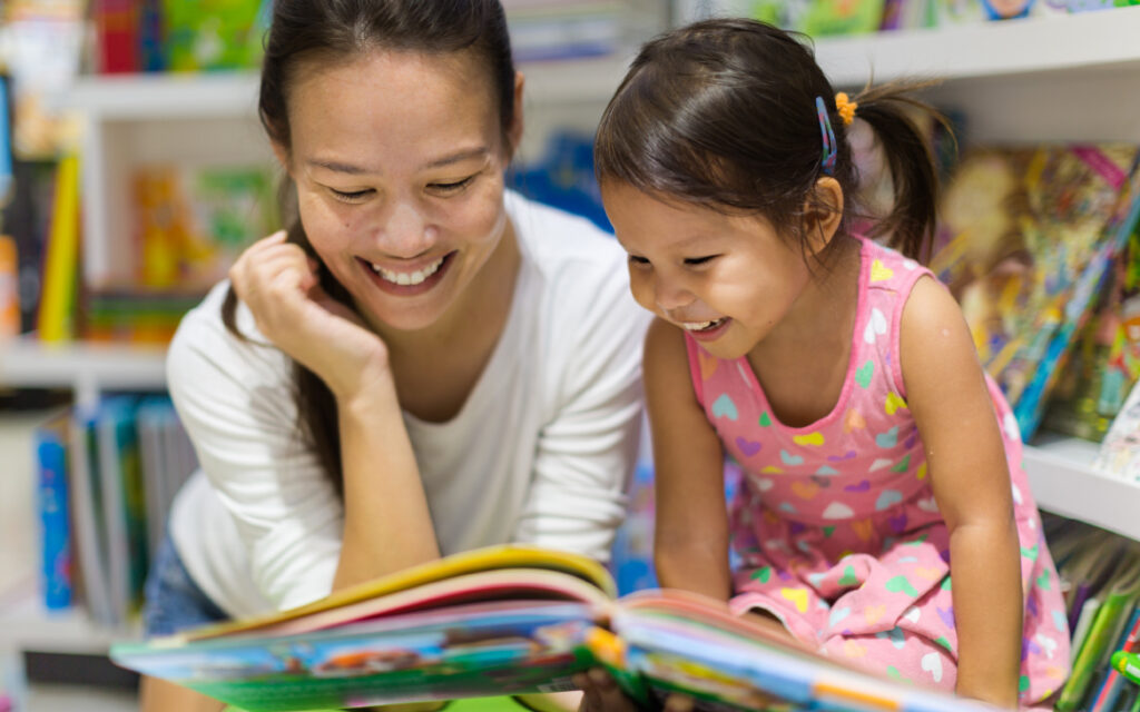 mother and young daughter reading